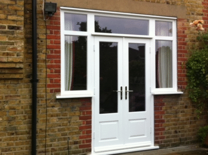 White uPVC French doors with side windows on a brick rear extension
